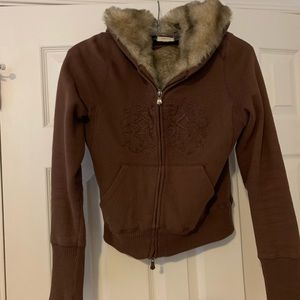 Hooded faux fur lined zip up jacket.
